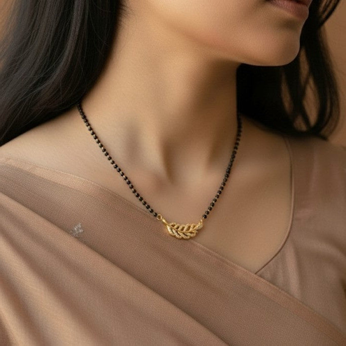 a women in beige color saree wearing mangalsutra