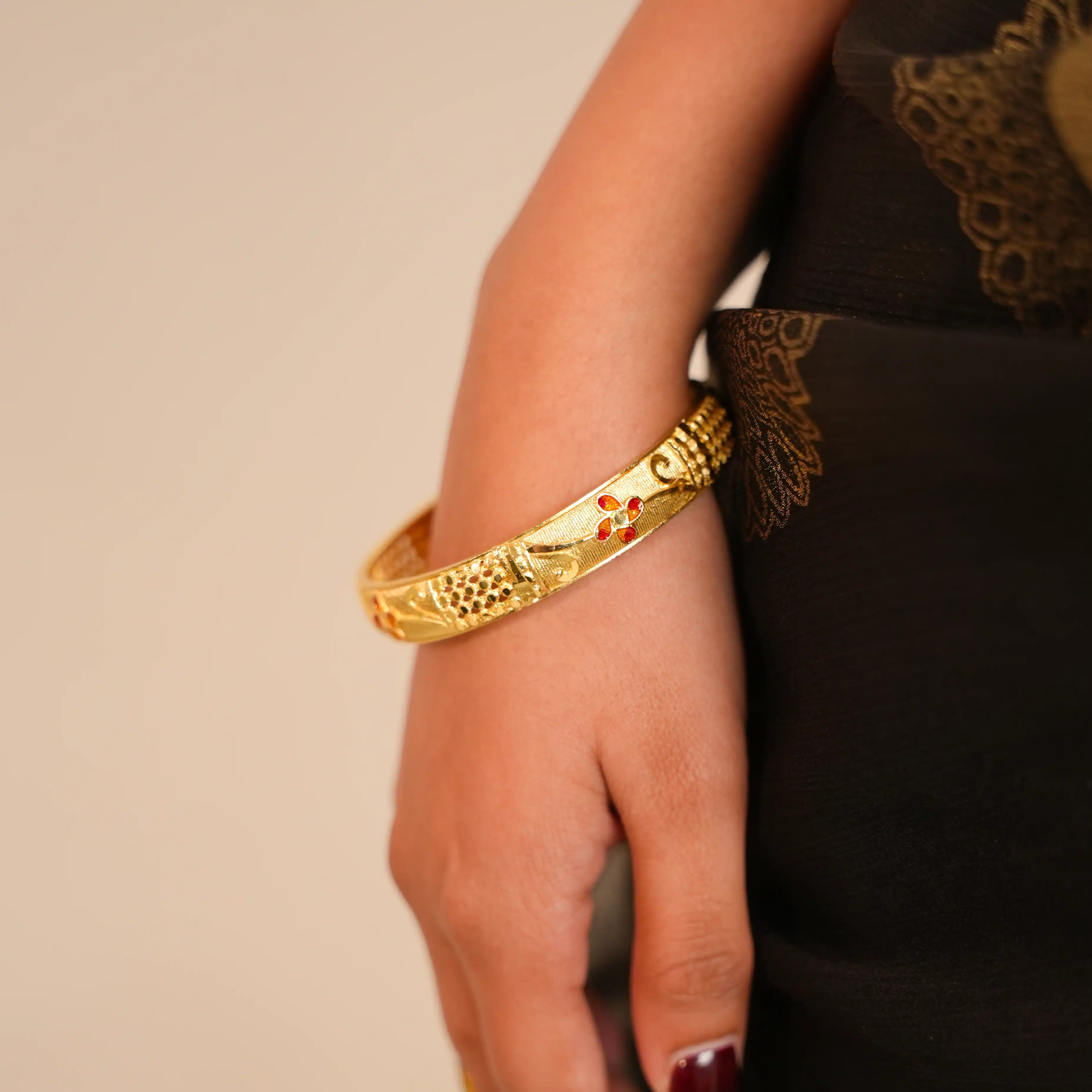 Gold bracelet on a wrist with a blurred background