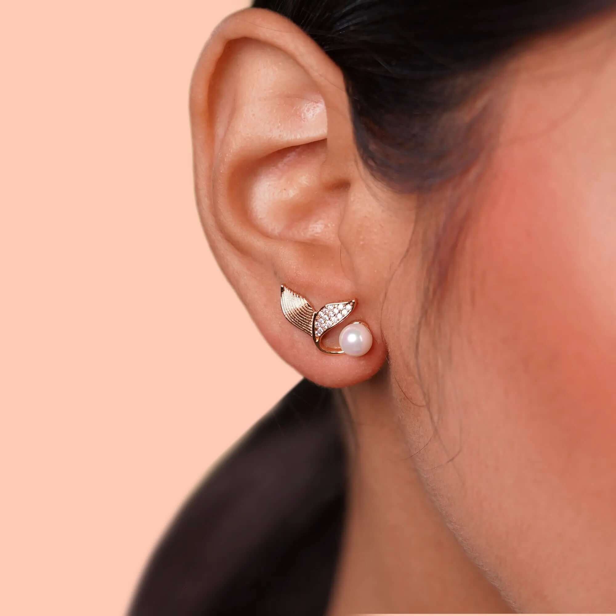 Elegant pearl stud earrings for women – gold-plated leaf design with sparkling CZ stones, premium imitation fashion jewellery ideal for party wear, bridal look, and gifting.