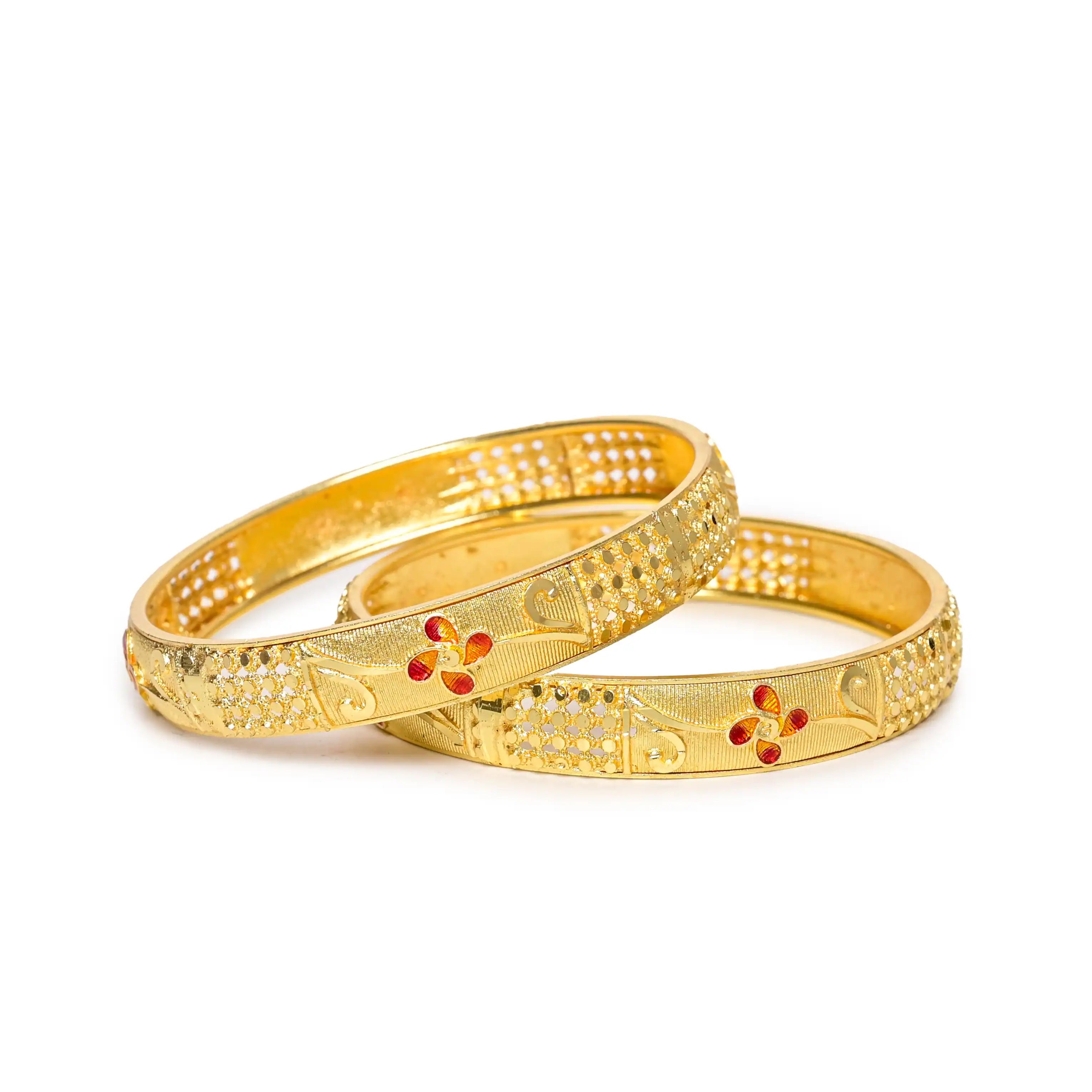 Two gold bangles with intricate designs on a white background