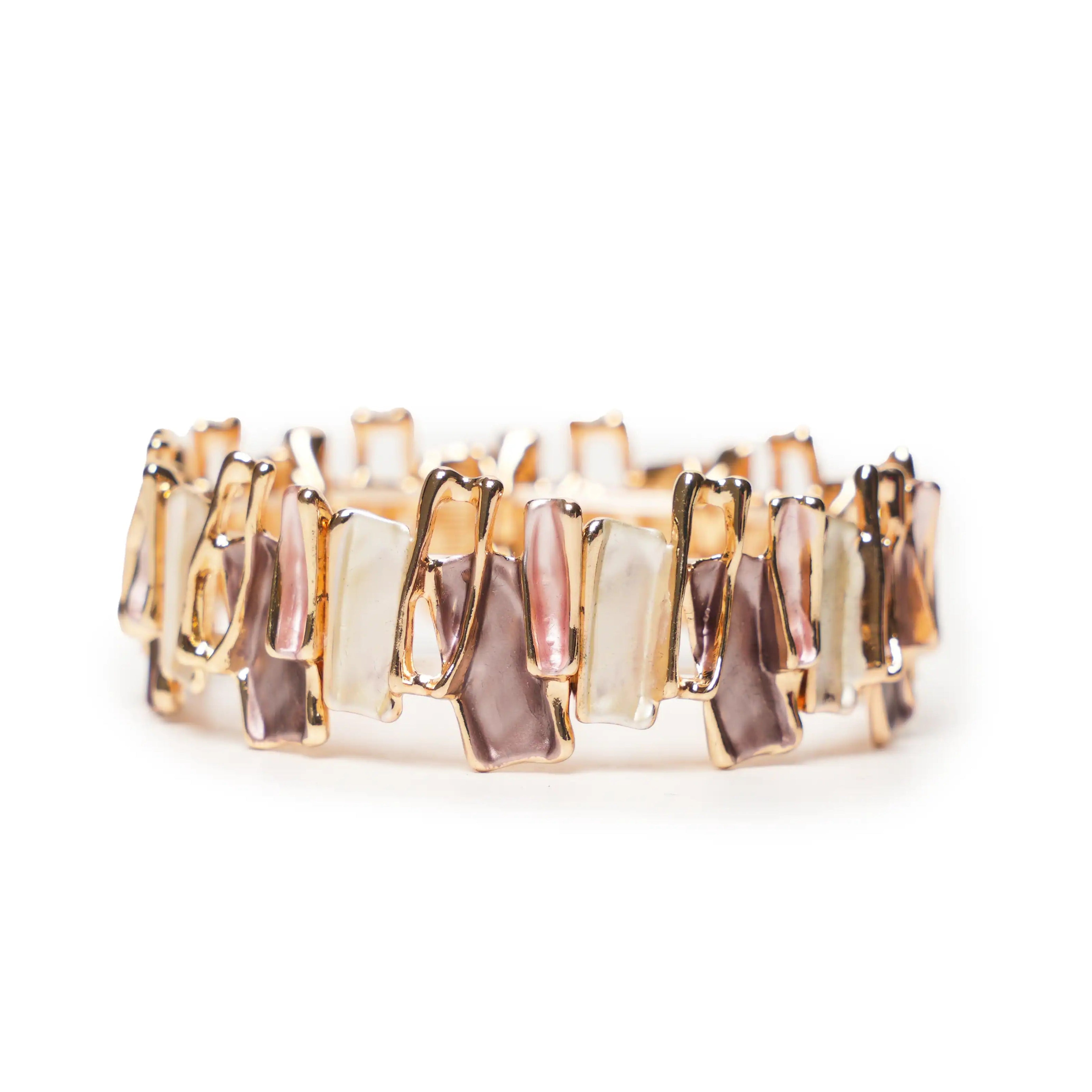 Gold and rose gold ring with rectangular stones on a white background