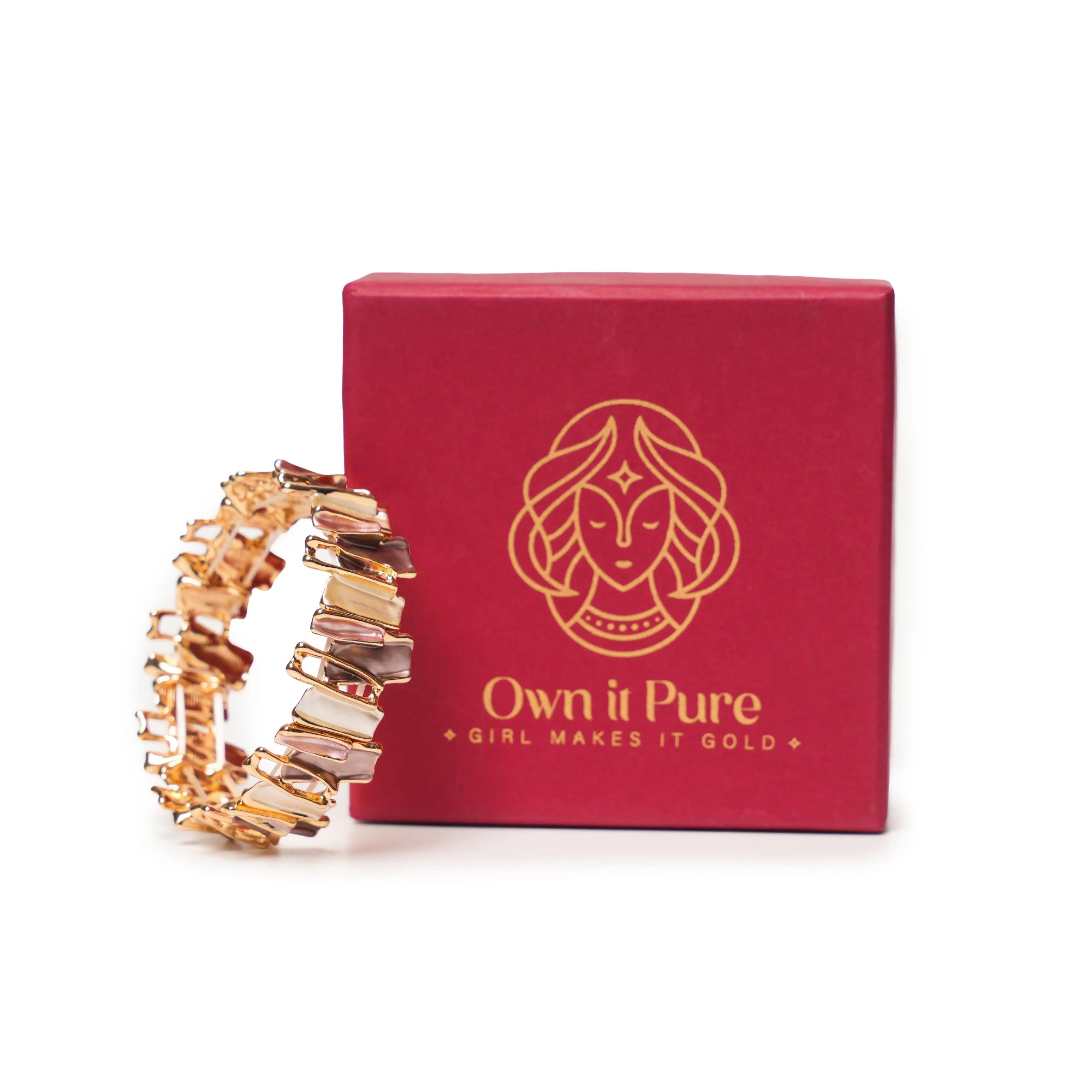 Gold bracelet next to a red box with 'Own it Pure' branding on a white background