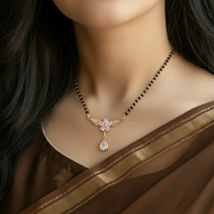 Necklace with a floral pendant on a mannequin wearing a brown saree.