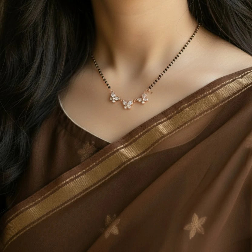 Necklace with floral design worn by a person in a brown saree