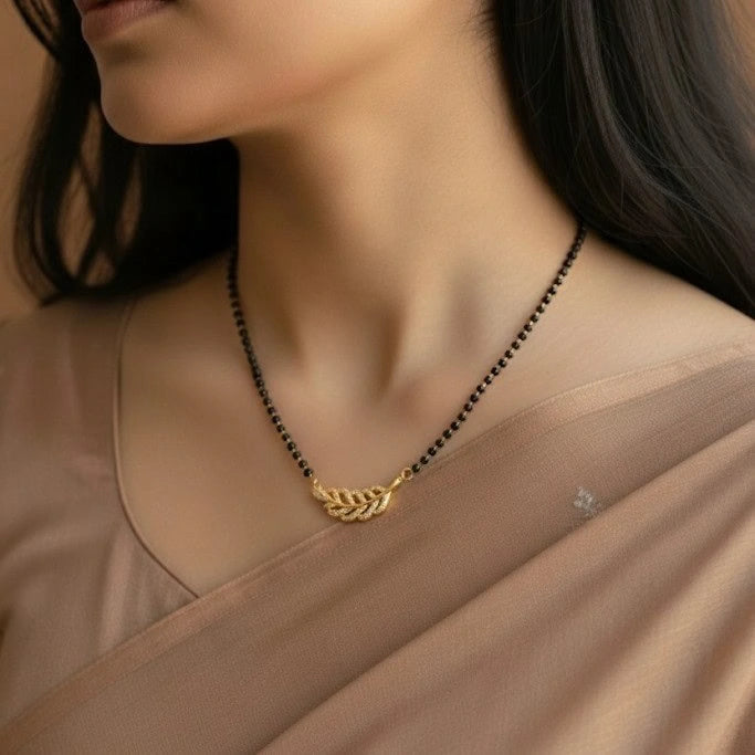 Woman wearing a gold necklace with a blurred background