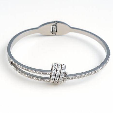 Silver bracelet with diamond accents on a white background