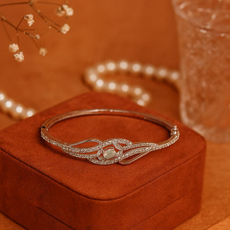 Silver bracelet on a brown jewelry box with a blurred background