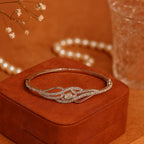 Silver bracelet on a brown jewelry box with a blurred background