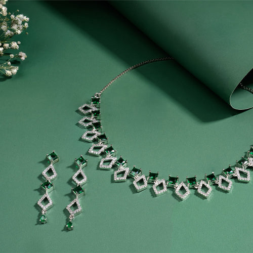 Elegant necklace with green gemstones on a green background