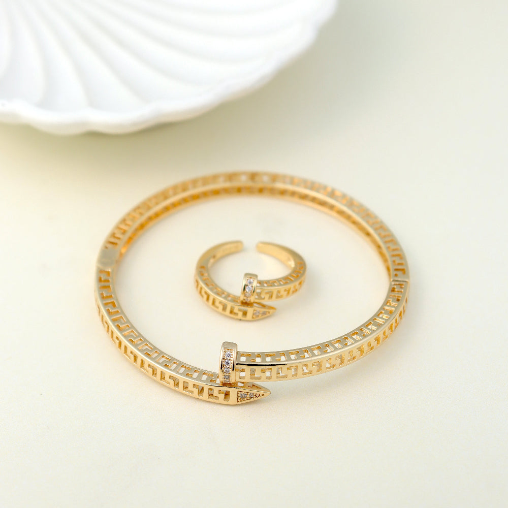 Luxury gold-plated open bangle bracelet and adjustable ring with Greek key design and sparkling cubic zirconia stones. Perfect for modern statement jewelry, minimalist accessories, and premium gift collections. open cuff bracelet, geometric jewelry, statement ring, premium fashion accessories.