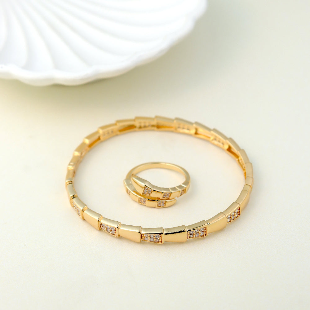 Elegant gold-plated jewelry set featuring a stylish bracelet and matching ring with cubic zirconia accents. Perfect for wedding accessories, party wear, and luxury gift ideas. (Unique keywords: cubic zirconia bracelet, designer ring set, fashion jewelry gift