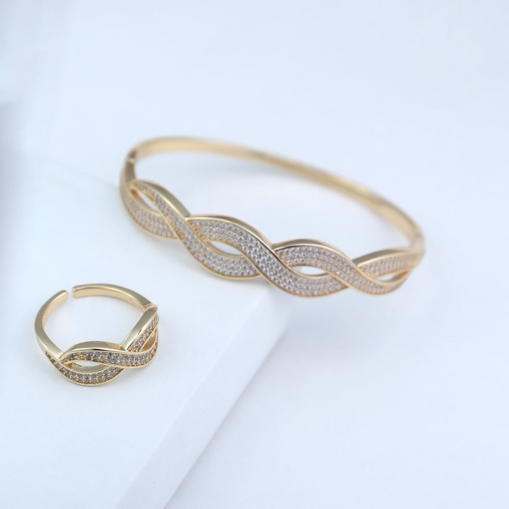 Elegant gold-plated bracelet and ring set with intertwined infinity design, encrusted with sparkling cubic zirconia stones – luxury jewelry by Own It Pure. Perfect for formal occasions, gifts, or everyday elegance. Shop high-quality gold accessories today.