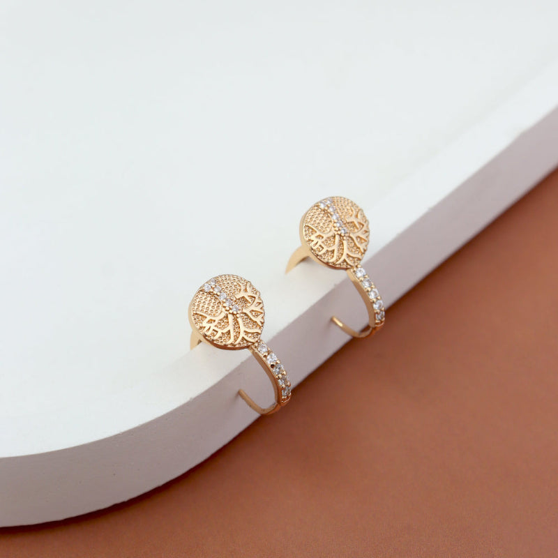 Gold-plated designer earrings with intricate floral motifs and American diamond accents, displayed on a minimal white and brown background – premium imitation jewelry by Own It Pure."

Let me know if you'd like a shorter version or one focused on specific keywords like “wedding,” “ethnic,” or daily wear .