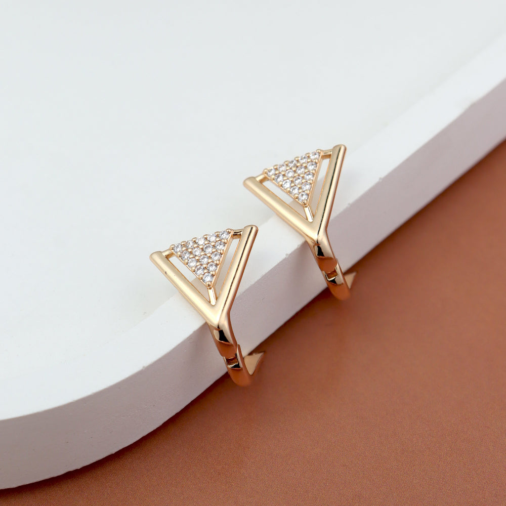 Chic gold-toned earrings featuring a modern V-shaped design with a triangle accent encrusted with sparkling American diamonds. Displayed elegantly on a white and brown background, highlighting their contemporary and luxurious appeal.