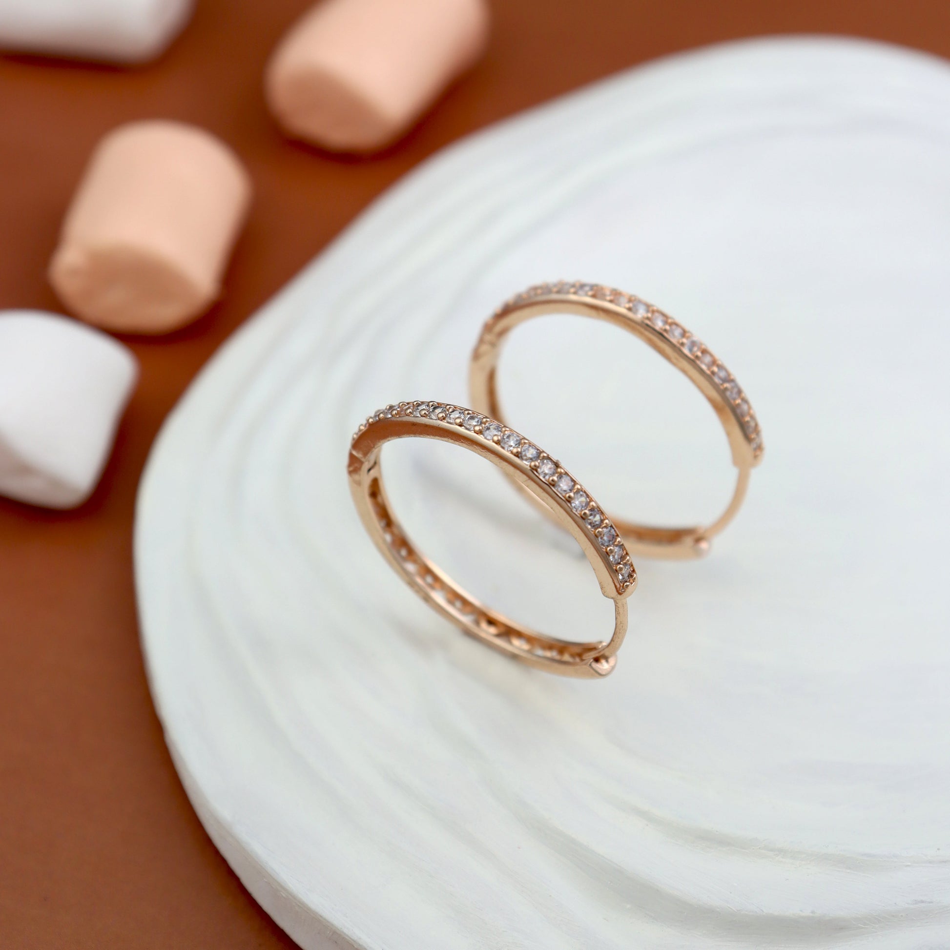 Elegant rose gold hoop earrings encrusted with sparkling cubic zirconia stones. These classic and stylish huggie hoops are perfect for women’s daily wear, weddings, and party jewellery. Anti-tarnish, lightweight, and trendy fashion accessories.