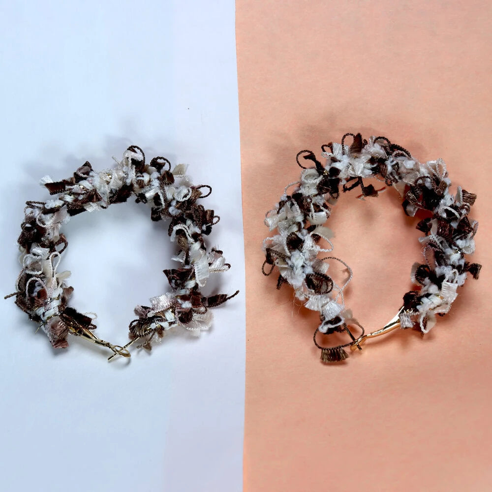 Bracelet with natural elements on a light blue and peach background