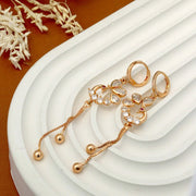 Gold jewelry set with earrings on a white surface