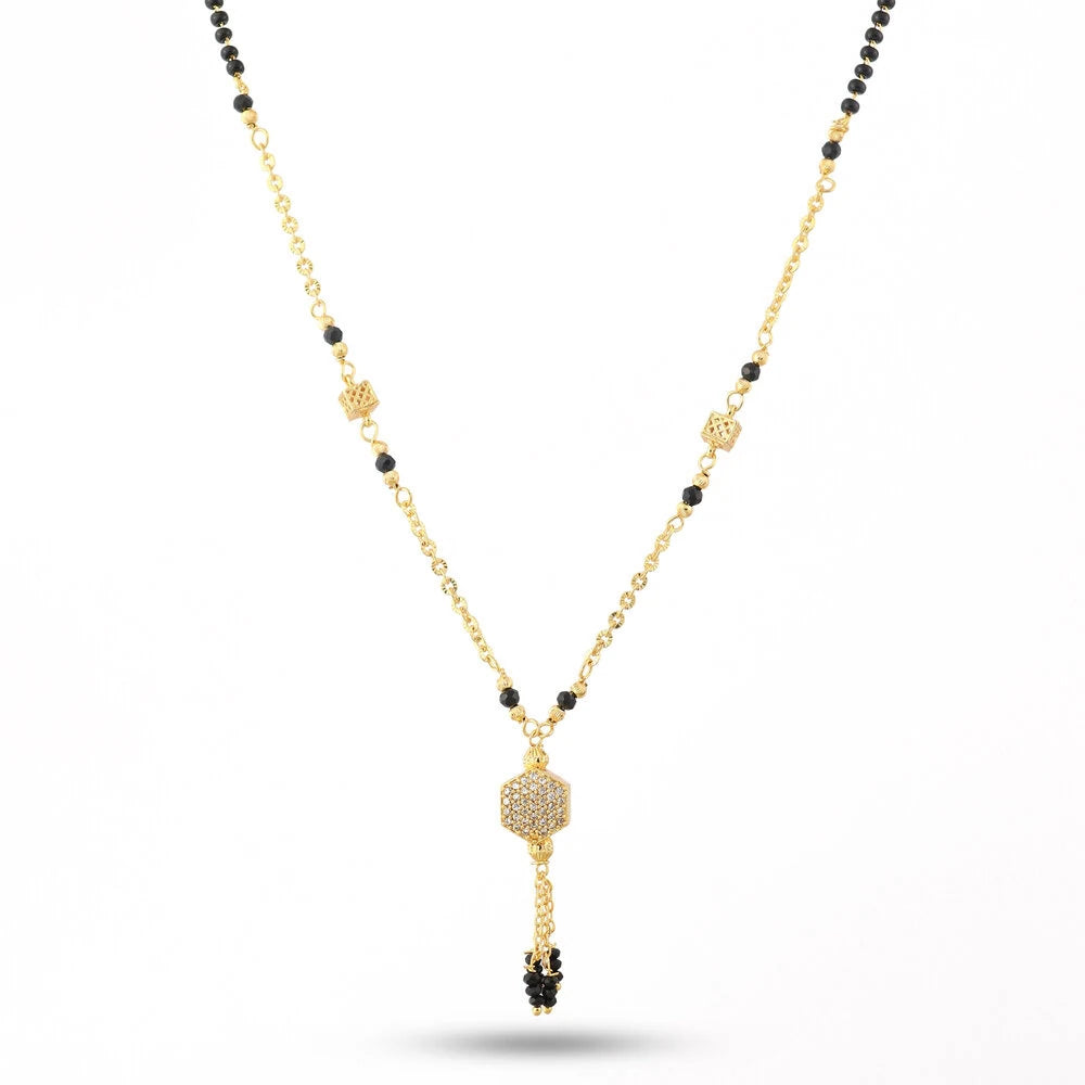 Gold necklace with black beads on a white background