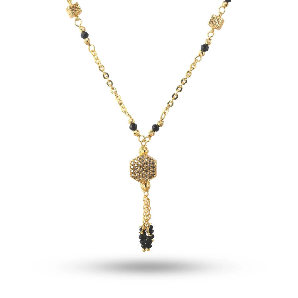 Gold necklace with black beads on a white background