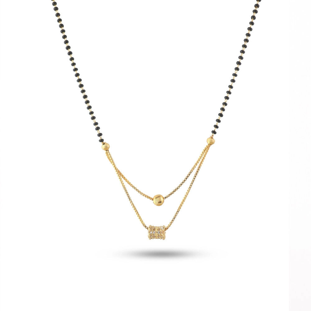 Two-layered necklace with gold chain and black beads on a white background