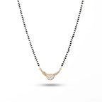 Necklace with black beads and a gold pendant on a white background