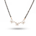 Necklace with black beads and butterfly-shaped pendants on a white background
