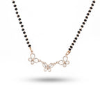 Necklace with black beads and butterfly-shaped pendants on a white background