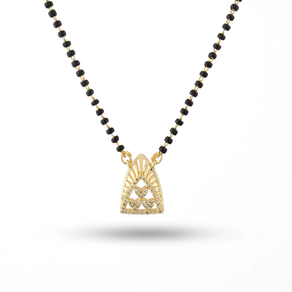 Necklace with black beads and a gold pendant on a white background