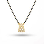 Necklace with black beads and a gold pendant on a white background