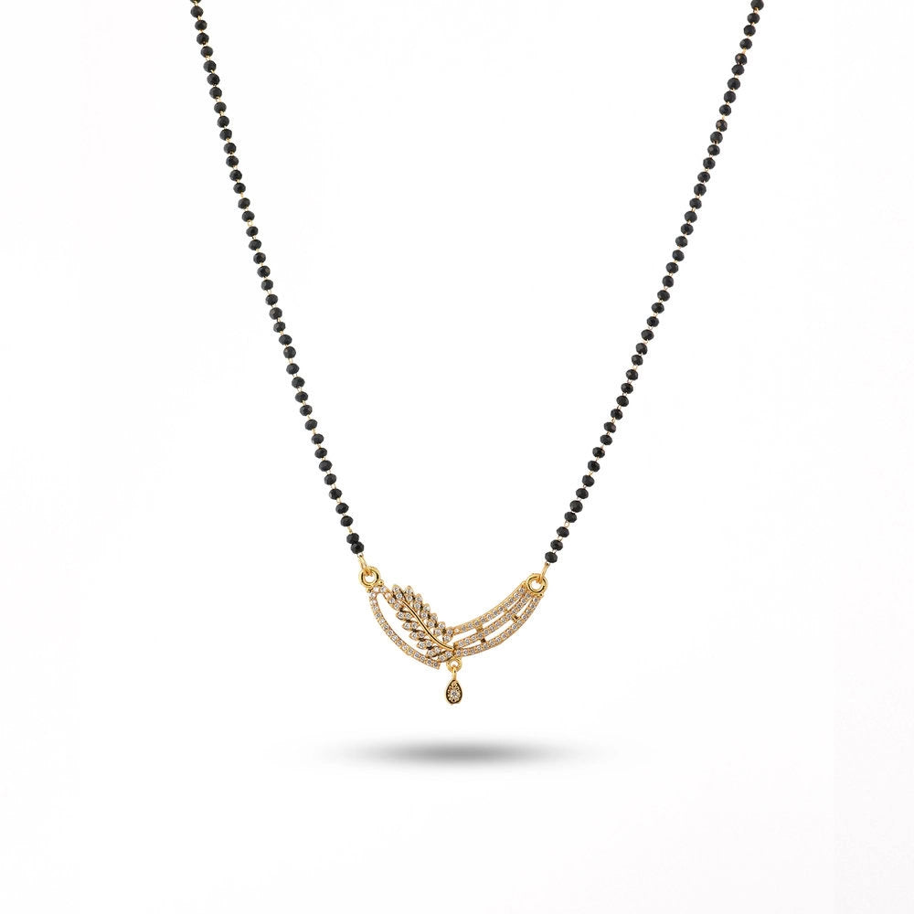 Necklace with black beads and gold pendant on a white background