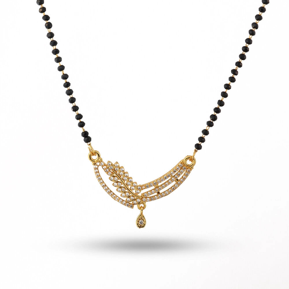 Black beaded necklace with a gold pendant on a white background