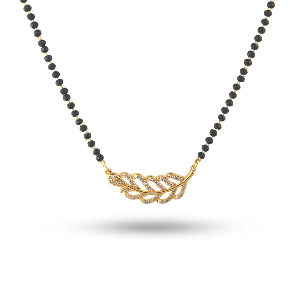 Necklace with black beads and a gold leaf pendant on a white background