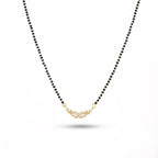 Necklace with black beads and a gold clasp on a white background