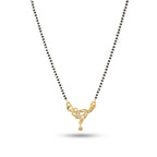 Necklace with black beads and a gold heart-shaped pendant on a white background