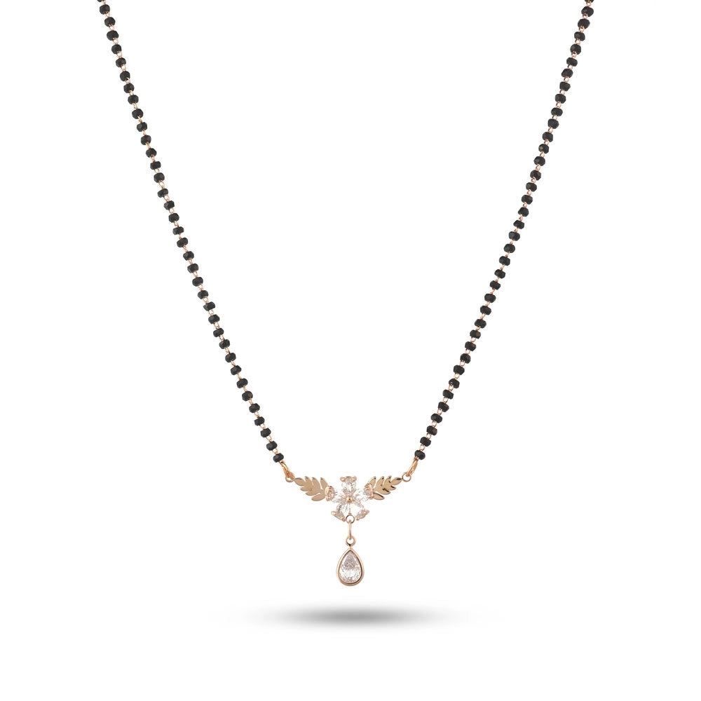 Necklace with black beads and a rose gold pendant on a white background