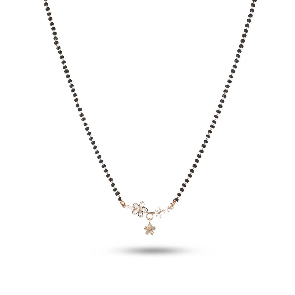 Necklace with black beads and gold flower pendants on a white background