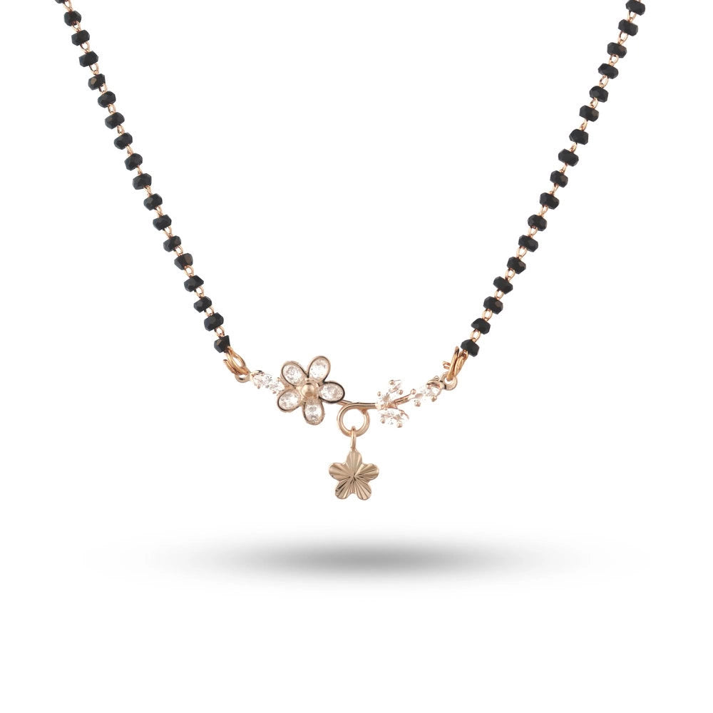 Necklace with black beads and gold charms on a white background