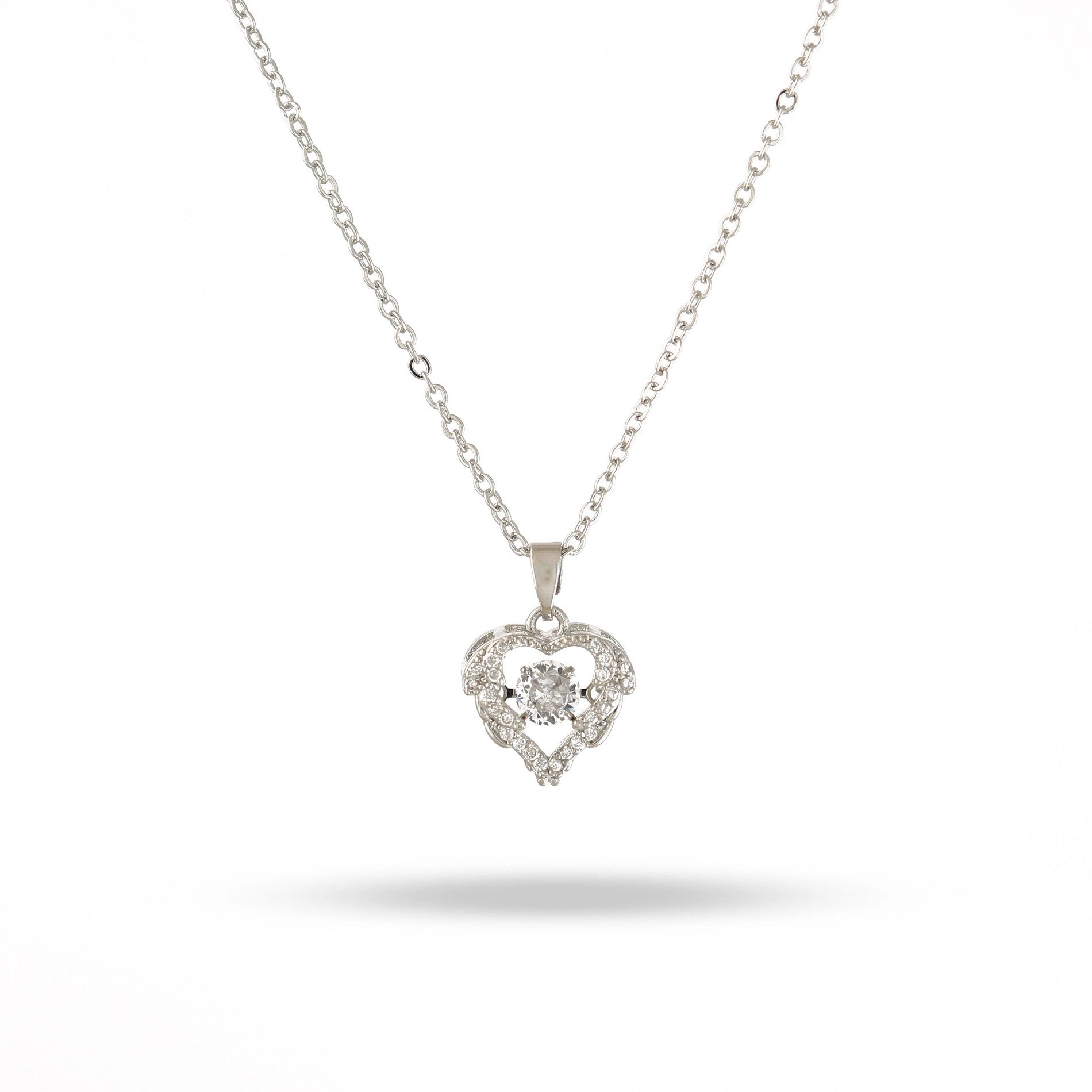 Heart-shaped diamond pendant on a chain against a white background