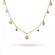 Gold necklace with round pendants on a white background