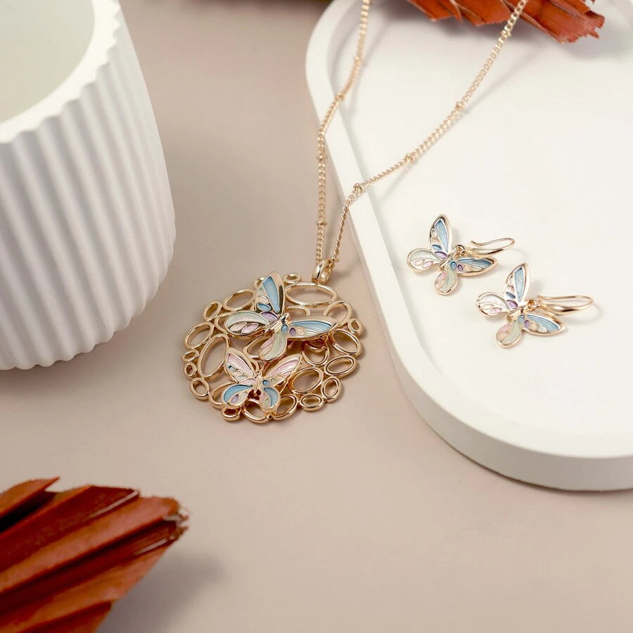 Butterfly-themed jewelry set with necklace and earrings on a neutral background