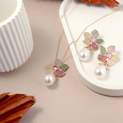 Jewelry set with floral design and pearls on a beige surface
