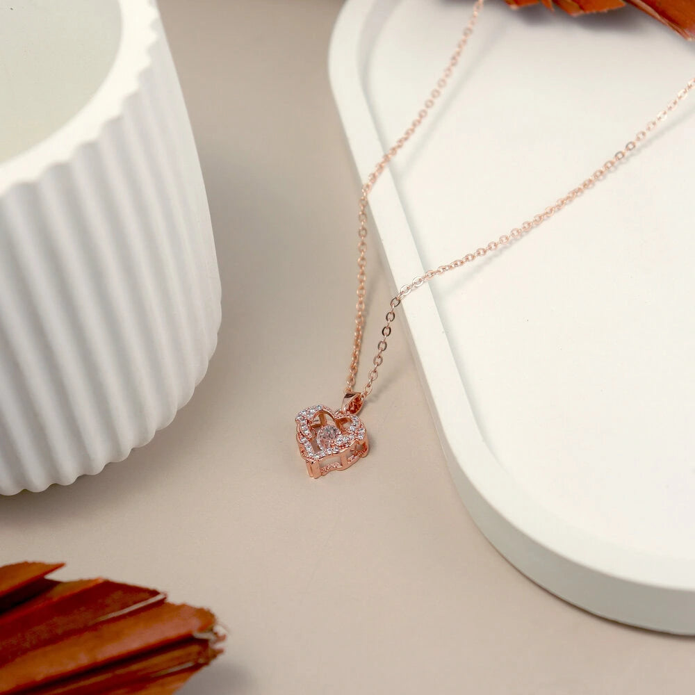 Rose gold necklace with a pendant on a white surface