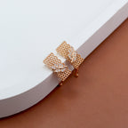 Contemporary gold mesh design earrings with sparkling leaf-shaped American diamond accents – stylish statement earrings for women, perfect for festive and party wear by Own It Pure.