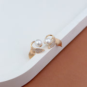 Elegant pearl stud earrings for women – gold-plated leaf design with sparkling CZ stones, premium imitation fashion jewellery ideal for party wear, bridal look, and gifting.